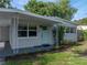 Charming home exterior featuring updated paint, mature landscaping, and a covered carport at 1140 W Seminole Trl, Bartow, FL 33830
