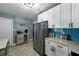 Kitchen with stainless steel appliances, shaker cabinets, blue backsplash, and light wood-look tile floors at 1140 W Seminole Trl, Bartow, FL 33830
