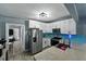 Updated kitchen features stainless appliances, gray countertops, white cabinets, and blue backsplash at 1140 W Seminole Trl, Bartow, FL 33830