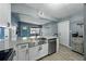 Kitchen with a stainless farmhouse sink, shaker cabinets, stainless appliances and breakfast bar seating at 1140 W Seminole Trl, Bartow, FL 33830