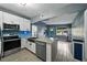 Bright kitchen featuring stainless steel appliances, breakfast bar, a blue backsplash, and open floor plan at 1140 W Seminole Trl, Bartow, FL 33830