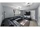 Modern living room with gray walls, wood-look floors, black leather sofa, and ample lighting at 1140 W Seminole Trl, Bartow, FL 33830