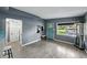 Open living space with gray walls, wood-look tile floors, and an inviting front entrance with a pop of color at 1140 W Seminole Trl, Bartow, FL 33830