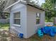 Exterior shot of the shed with freshly painted cinderblock and some items for lawn maintenance on the ground at 1140 W Seminole Trl, Bartow, FL 33830