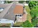 An aerial view of the property with a covered patio, outdoor seating and lush greenery at 118 Browning Cir, Winter Haven, FL 33884