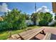 Backyard featuring a brick patio, picnic table, and mature landscaping at 118 Browning Cir, Winter Haven, FL 33884