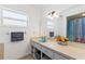 Bright bathroom with a spacious countertop, decorative mirror, and window offering natural light at 118 Browning Cir, Winter Haven, FL 33884