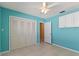 Bedroom features a closet, ceiling fan, and extra storage, providing ample space at 118 Browning Cir, Winter Haven, FL 33884