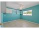 Bright bedroom features custom shelving, a ceiling fan, and a large window letting in natural light at 118 Browning Cir, Winter Haven, FL 33884