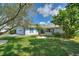 Charming home with a well-manicured lawn, white exterior, and blue accents, enhancing curb appeal at 118 Browning Cir, Winter Haven, FL 33884