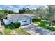 Inviting single-story home with attached two-car garage and beautifully landscaped front yard at 118 Browning Cir, Winter Haven, FL 33884