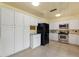 Spacious kitchen with white cabinetry, stainless steel appliances, and tile flooring, ideal for culinary enthusiasts at 118 Browning Cir, Winter Haven, FL 33884
