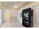 Functional kitchen layout with a black refrigerator, white cabinets, and access to adjoining rooms for convenience at 118 Browning Cir, Winter Haven, FL 33884