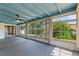 Enclosed lanai with ceiling fan, neutral colors, and view of the well maintained backyard at 118 Browning Cir, Winter Haven, FL 33884