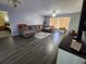 Cozy living room featuring hardwood floors, a comfy sectional sofa, and a ceiling fan for added comfort at 118 Browning Cir, Winter Haven, FL 33884