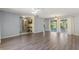 Spacious living room featuring modern flooring and ample space for entertaining, with access to porch at 118 Browning Cir, Winter Haven, FL 33884