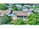 Aerial view of the home's rear with screened in porch, fenced yard, and mature trees at 118 Browning Cir, Winter Haven, FL 33884