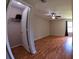 Bright bedroom with a closet, wood-look floors, and neutral-colored walls at 12241 Augusta Woods Cir, Orlando, FL 32824