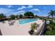 Beautiful community pool with sun loungers and umbrellas on a sunny day at 12241 Augusta Woods Cir, Orlando, FL 32824