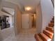 Open floor plan showcasing kitchen access, front entrance and hardwood staircase at 12241 Augusta Woods Cir, Orlando, FL 32824