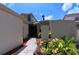 Welcoming townhome entrance with tiled walkway, lush plants, and decorative lighting at 12241 Augusta Woods Cir, Orlando, FL 32824