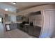 Stylish kitchen with stainless steel appliances, granite countertops, and a pantry at 12241 Augusta Woods Cir, Orlando, FL 32824