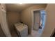 Functional laundry room with white appliances and easy access to the backyard at 12241 Augusta Woods Cir, Orlando, FL 32824