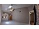 Bright living room with vaulted ceilings, ceiling fan, skylight and easy access to other rooms at 12241 Augusta Woods Cir, Orlando, FL 32824