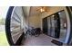 Covered patio with tiled floor, ceiling fan, and sliding glass doors leading to the home interior at 12241 Augusta Woods Cir, Orlando, FL 32824