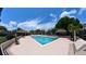 Community pool with ample lounge seating and a covered cabana area, perfect for relaxation and socializing at 12241 Augusta Woods Cir, Orlando, FL 32824