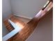 Staircase with wood-look flooring and white banister leading to the upper level of the home at 12241 Augusta Woods Cir, Orlando, FL 32824