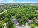 An aerial view captures the property, showcasing its location amidst lush greenery and neighboring homes at 125 Homewood Dr, Winter Haven, FL 33880