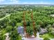 Aerial view of a home emphasizing its location amidst abundant trees and landscaping at 125 Homewood Dr, Winter Haven, FL 33880