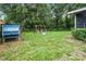 The backyard is very spacious with a swing set and some trees, fenced in for privacy at 125 Homewood Dr, Winter Haven, FL 33880