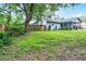 The backyard features lush greenery and is fully fenced for privacy, along with the house visible at 125 Homewood Dr, Winter Haven, FL 33880