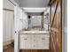 Bathroom features a double sink vanity with granite counters and a sliding barn door at 125 Homewood Dr, Winter Haven, FL 33880