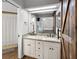 Bathroom features a double sink vanity with granite counters and a sliding barn door at 125 Homewood Dr, Winter Haven, FL 33880