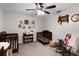Bright bedroom with wood ceiling fan, cribs, bookshelf, rocking chair at 125 Homewood Dr, Winter Haven, FL 33880
