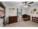 Bright bedroom with a wood ceiling fan, changing table, crib, and bookshelf at 125 Homewood Dr, Winter Haven, FL 33880