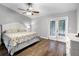 Spacious bedroom featuring wood floors, a ceiling fan, and french doors to a balcony at 125 Homewood Dr, Winter Haven, FL 33880