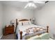 Bedroom with wood bed frame, nightstand, lamps, ceiling fan, and bright light at 125 Homewood Dr, Winter Haven, FL 33880