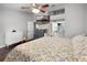 Bedroom featuring wood floors, a ceiling fan, and ensuite bathroom for comfortable living at 125 Homewood Dr, Winter Haven, FL 33880