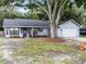 Inviting single-story home with a welcoming front porch and well-maintained landscaping at 125 Homewood Dr, Winter Haven, FL 33880