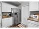 Bright kitchen featuring stainless steel appliances, granite countertops, and white cabinetry at 125 Homewood Dr, Winter Haven, FL 33880