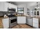Bright and efficient kitchen with stainless steel appliances and granite countertops at 125 Homewood Dr, Winter Haven, FL 33880