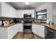 Well-equipped kitchen featuring stainless steel appliances and beautiful granite countertops at 125 Homewood Dr, Winter Haven, FL 33880