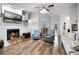 Cozy living room with a fireplace, hardwood floors, and comfortable seating at 125 Homewood Dr, Winter Haven, FL 33880
