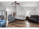 Open-concept living room with hardwood floors, ample seating, and natural light at 125 Homewood Dr, Winter Haven, FL 33880