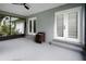 The screened porch features gray floors and walls, and white french doors, providing an indoor/outdoor living space at 125 Homewood Dr, Winter Haven, FL 33880