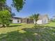 Expansive backyard featuring a screened lanai and lush green grass at 14191 Se 25Th Ave, Summerfield, FL 34491